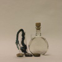 Annie Morris & Kim Wan together… (30/08/2015) - Two bottles gathered separately…A.M is Campani & Soda bottle collected from Hastings fishing beach with blue rope. K.W is Limoncello bottle from Chalybeate Spring Silverhill with 3 stones. Chalybeate Spring is Iron Red Water. Limoncello bottle from Naples.